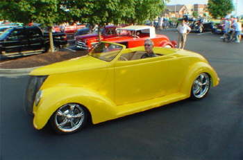 Here we have Ron Hassel's ULTRA cool '37 Ford Roadster.  That's 'ol Ron driving.  Ron's from Palm City, FL.    