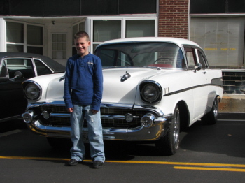 Blake posing in front of Betty and Lonnie Robinsons slick 57 Chevy