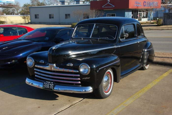 A '46 Ford Coupe with flipper hubcaps and fender skirts