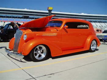 A dynomite shade of Orange on a Chevy sedan