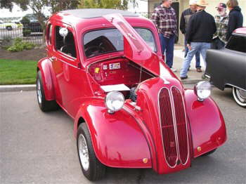 This red '54 Anglia has right hand drive and a four banger under the hood1