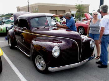 The Florida Love Bugs were out in force in some areas on this May evening.  After driving over from Windsor, FL, Bob Myers cleans off his 1941 Plymouth Coupe.