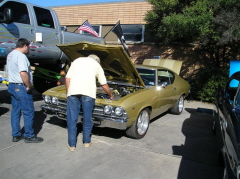 22  Jim Greene shows a spectator the finer points of his '69 Chevelle with a big block