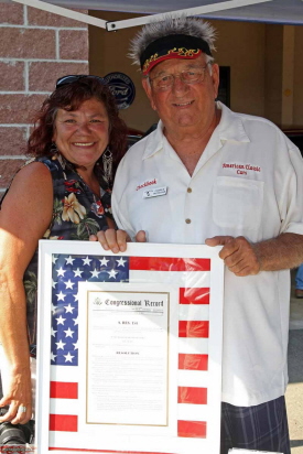 Senate Resolution 154, establishes July 8 as Collector Car Appreciation Day. Charlie Tachdjian and Carol, his daughter, hold the framed Resolution.