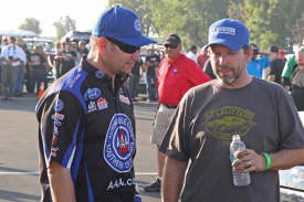 NHRA Funny Car pilot Robert Hight (l) talks with NHRA Top Fuel Dragster driver Del Worsham.