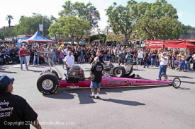 2 nostalgia Top Fuel dragsters were moved to the middle of the intersection and fired-up.  Fans held their ears as the Cackling put a grin on their faces.